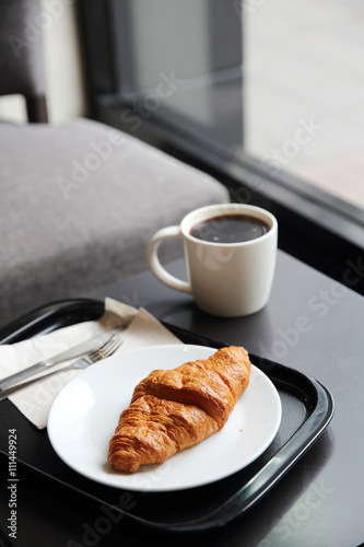 croissant and coffee in coffee shop