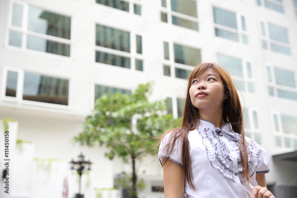 Young Asian bussiness woman standing over office background Young Asian bussiness woman standing over office background