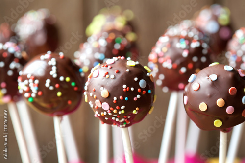 Homemade chocolate cake pops on a wooden background