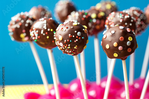 Chocolate cake pops on a blue background, selective focus