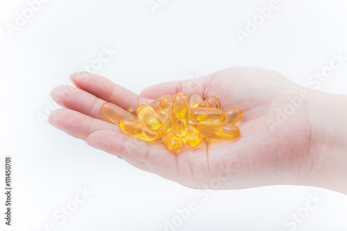Omega 3 fish oil capsule hold by a hand