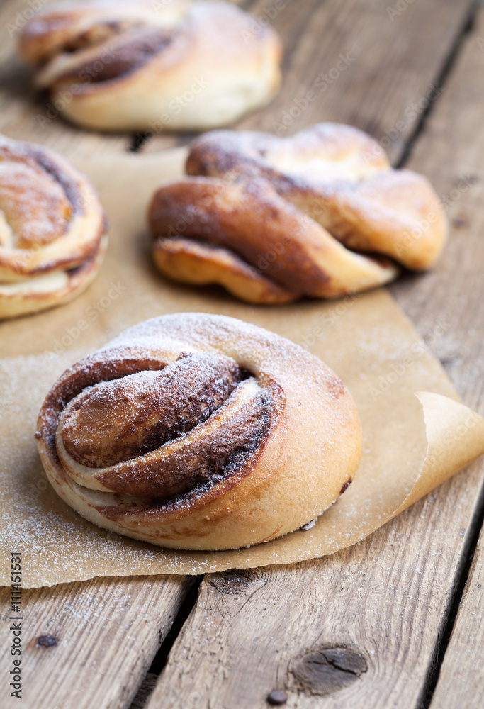 Homemade buns with chocolate and powdered sugar. Selective focus