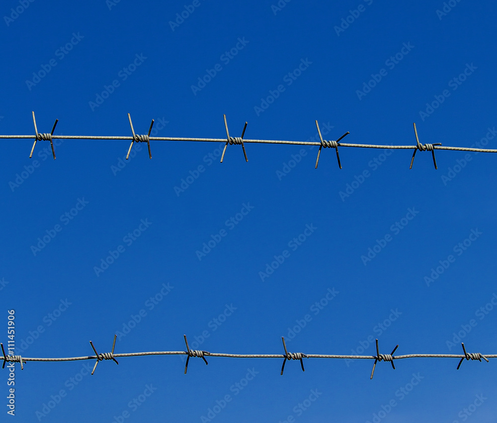 new barbed wire against the blue sky new barbed wire against the blue sky