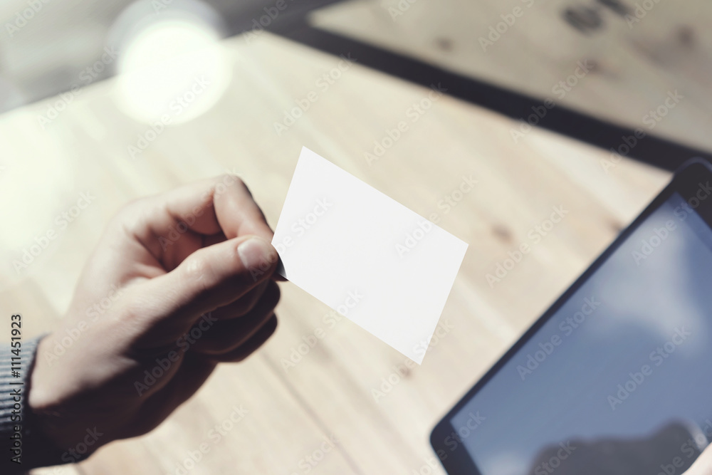 Closeup Man Showing Blank White Business Card, Holding Hand Modern Digital Tablet.Wood table Blurred Background.Mockup Ready Private Information.Sunlight Reflections Screen Gadget.Horizontal mockup. Closeup Man Showing Blank White Business Card, Holding Hand Modern Digital Tablet.Wood table Blurred Background.Mockup Ready Private Information.Sunlight Reflections Screen Gadget.Horizontal mockup.