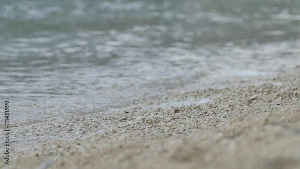 Beach and small waves pushed gravel - slow motion Beach and small waves pushed gravel - slow motion