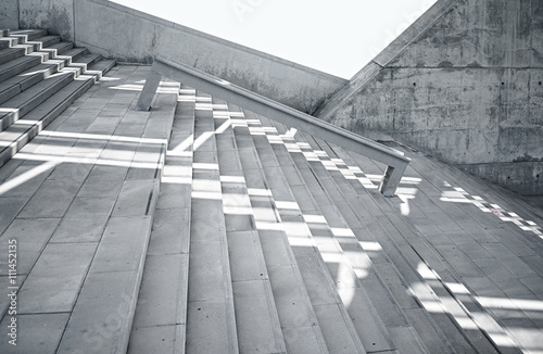 Horizontal Photo Blank Grungy and Smooth Bare Concrete Stairs with White Sunrays Reflecting on Surface. Empty Abstract background. Modern Architecture Building Image