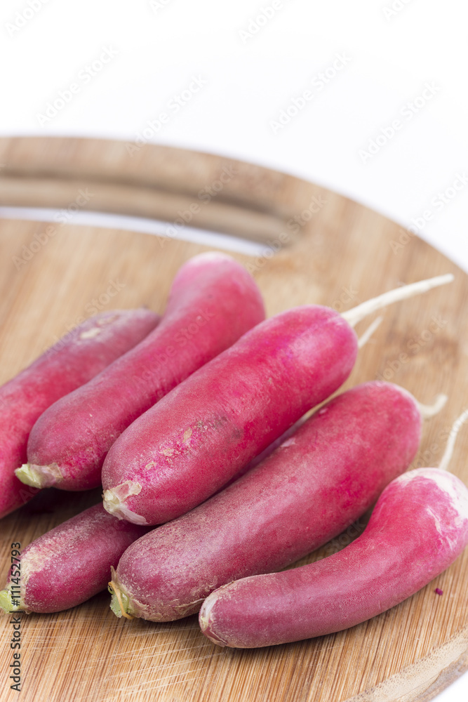 Close up macro red radishes on the wooden board Close up macro red radishes on the wooden board