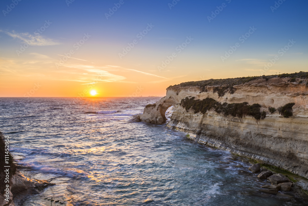 Malta - Sunrise at St.Thomas bay with clear blue sky