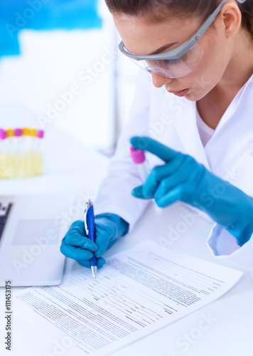 Woman researcher is surrounded by medical vials and flasks  isolated on white background