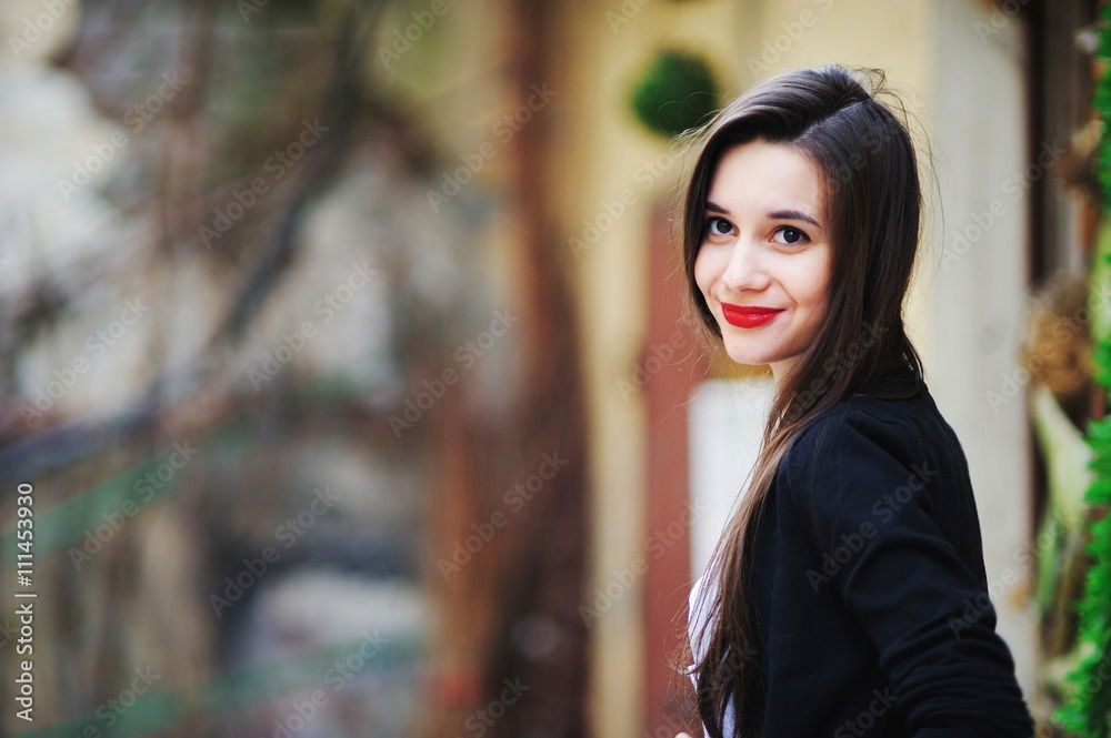 beautiful girl with long hair in a white shirt and a black cardigan looking with painted red lipstick lips