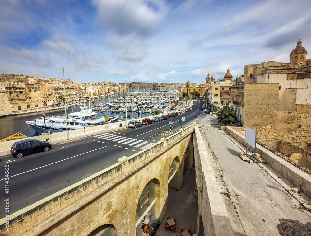 Malta - Birgu streetview on a sunny afternoon with blue sky and clouds