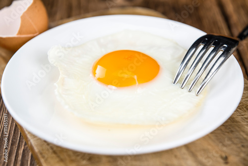 Wooden table with Fried Eggs (selective focus)