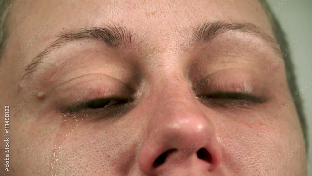 Young and real woman crying for real, close-up.
Young and real woman crying for real, close-up.