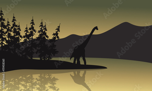 Silhouette of brachiosaurus in riverbank