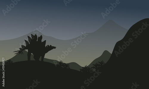 Silhouette of stegosaurus in hills