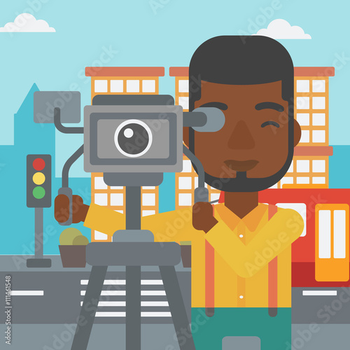 Cameraman with movie camera on a tripod.