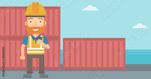 Stevedore standing on cargo containers background.