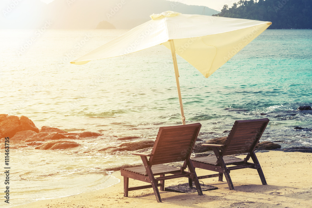 Beach chairs with parasol on the beach, soft focus, vintage tone