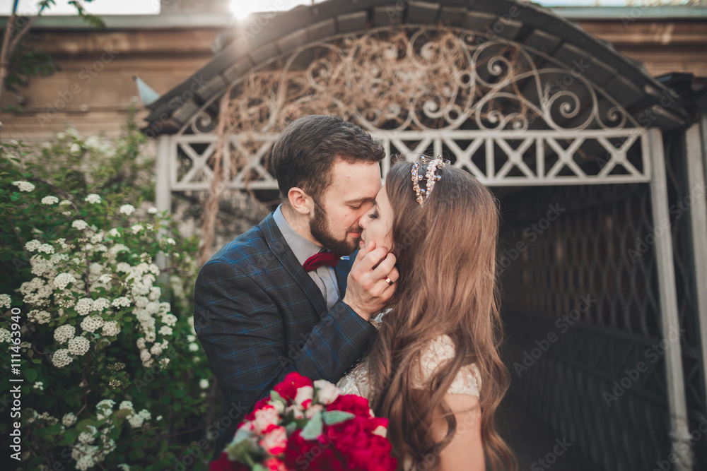 Kissing wedding couple in spring nature close-up portrait