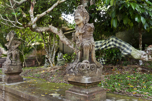 Old statues and decorated trees on the island of Bali, Indonesia 