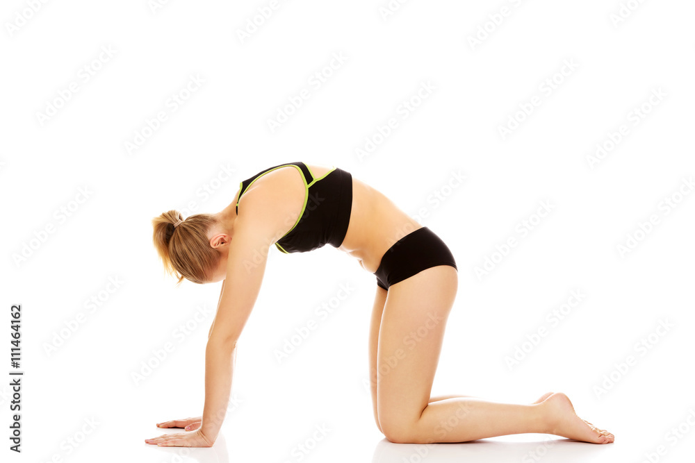 Young woman doing stretching exercise on the floor Young woman doing stretching exercise on the floor
