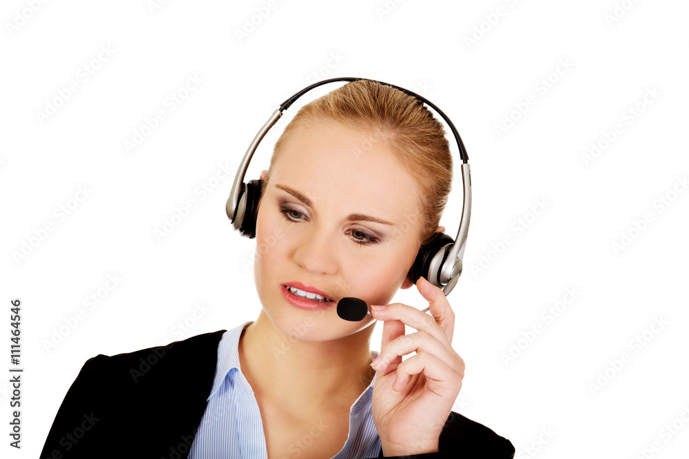 Young woman helpline operator is trying to hear something headphones Young woman helpline operator is trying to hear something headphones