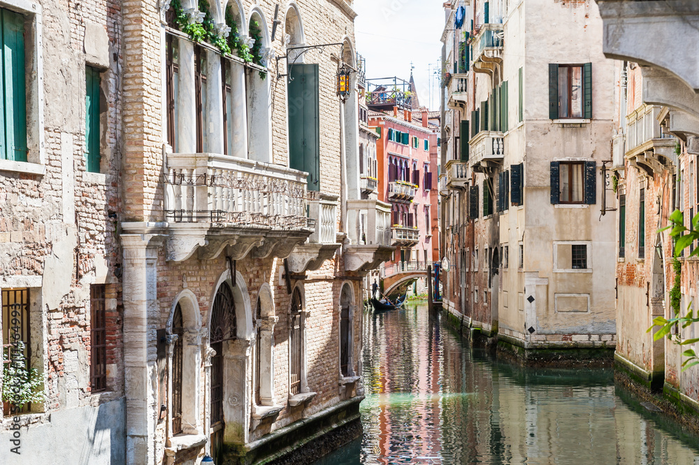Scenic canal with bridge and ancient buildings in Venice, Italy