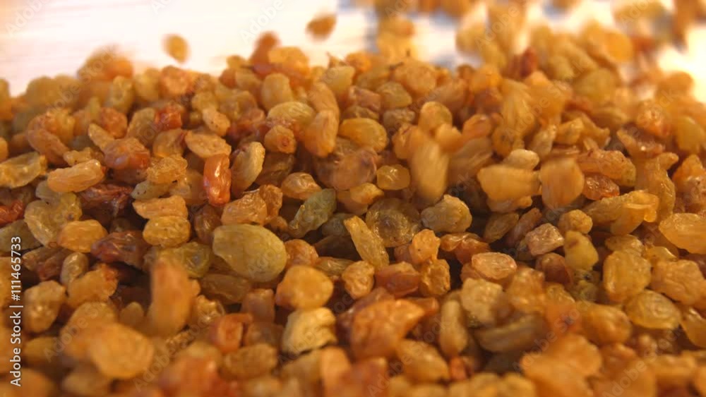 Raisins on a beige (texture table surface) background. 2 Shots. Horizontal pan. Close-up. Raisins on a beige (texture table surface) background. 2 Shots. Horizontal pan. Close-up.