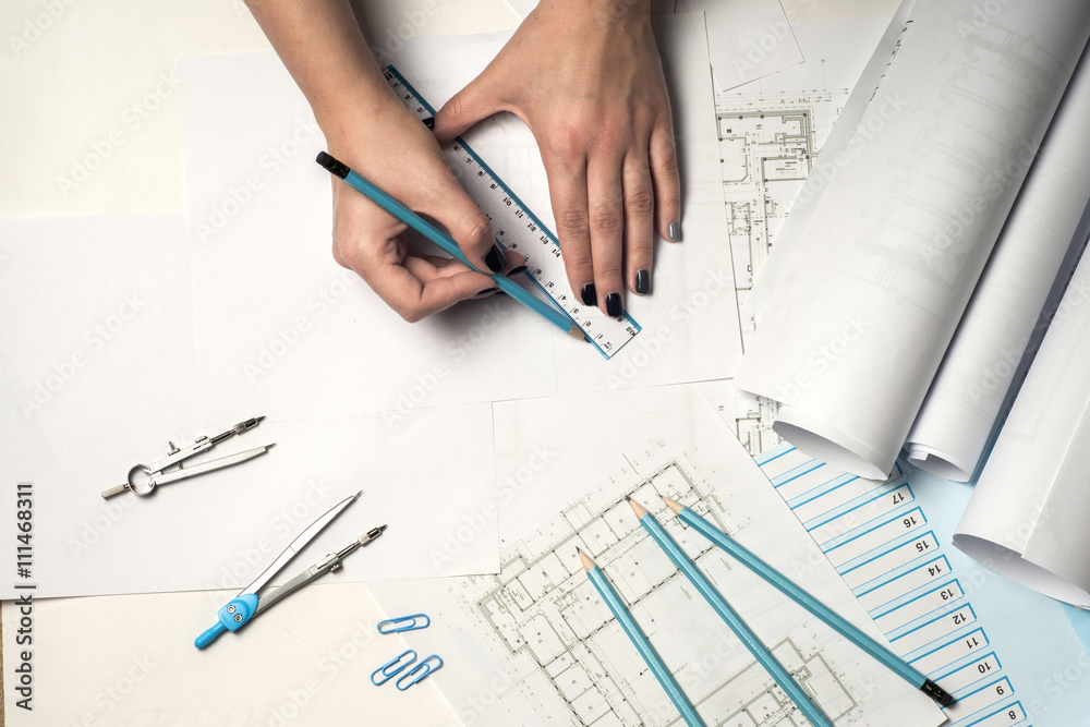 Workplace of architect - Architect rolls and plans. architectural plan,technical project drawing. Engineering tools view from the top. Construction background. Workplace of architect - Architect rolls and plans. architectural plan,technical project drawing. Engineering tools view from the top. Construction background.