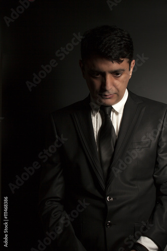 Studio portrait of a serious businessman wearing a black suit