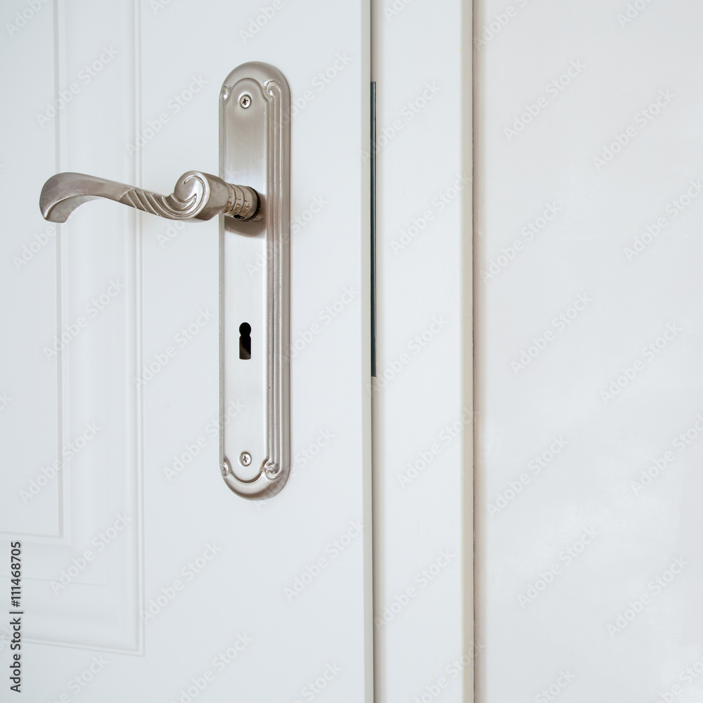 Horizontal view of door-handle in white door Horizontal view of door-handle in white door