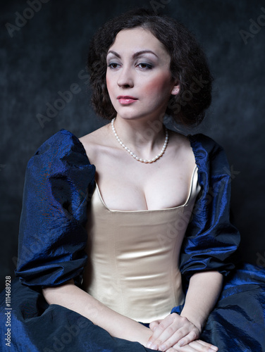 Beautiful girl wearing a medieval dress. XVII
