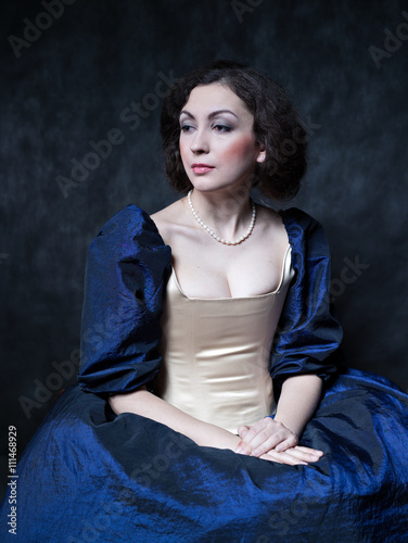 Beautiful girl wearing a medieval dress. XVII photo