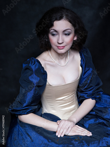 Beautiful girl wearing a medieval dress. XVII