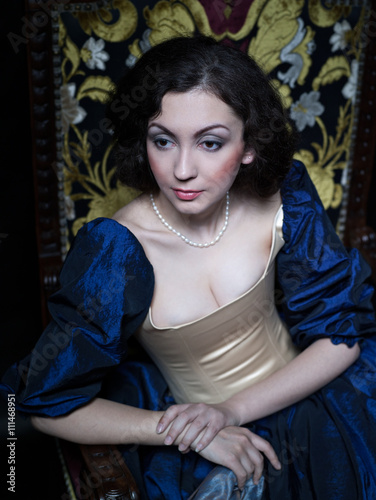 Beautiful girl wearing a medieval dress. XVII