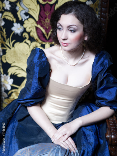 Beautiful girl wearing a medieval dress. XVII