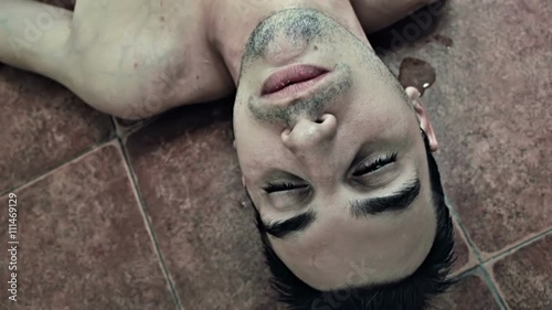 Drunk man on the floor with vomit on his face
