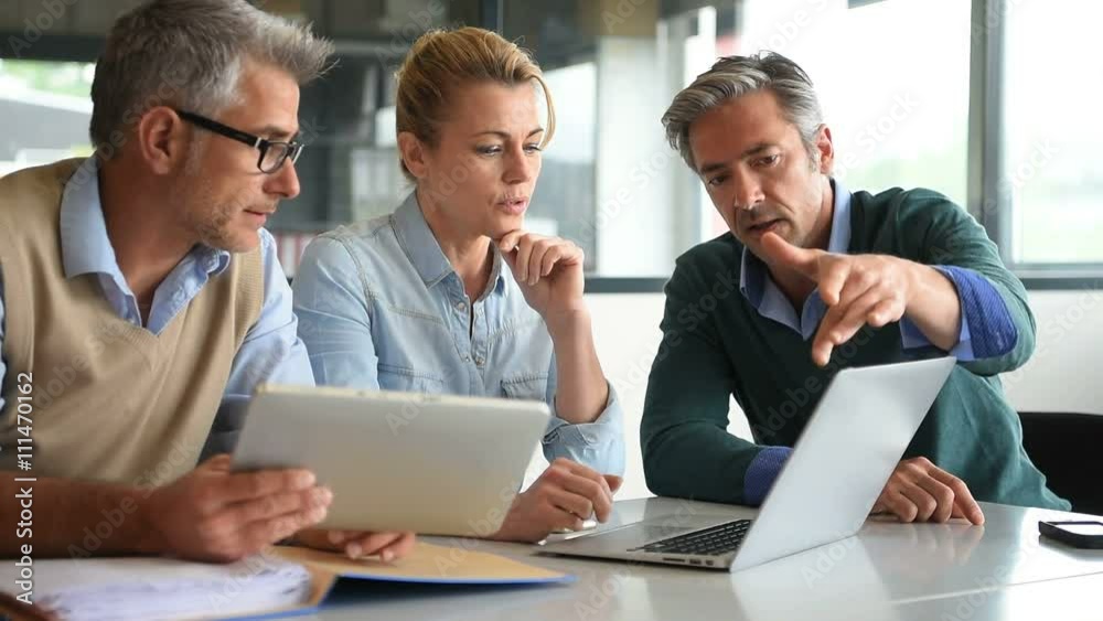 Business people in a meeting using tablet