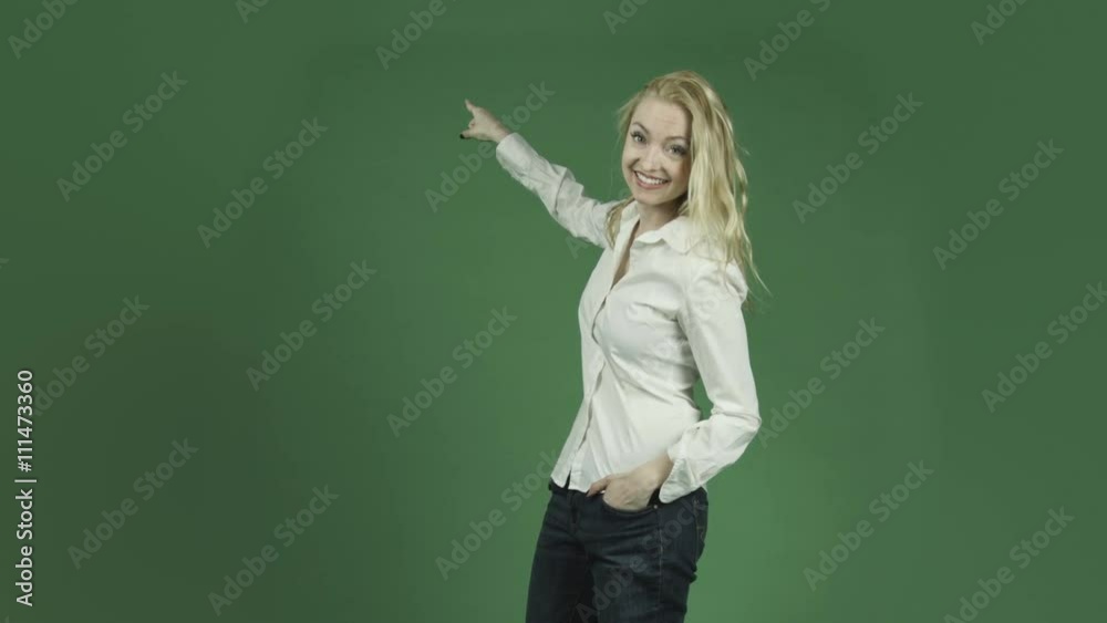 caucasian woman isolated on chroma green screen background pointing