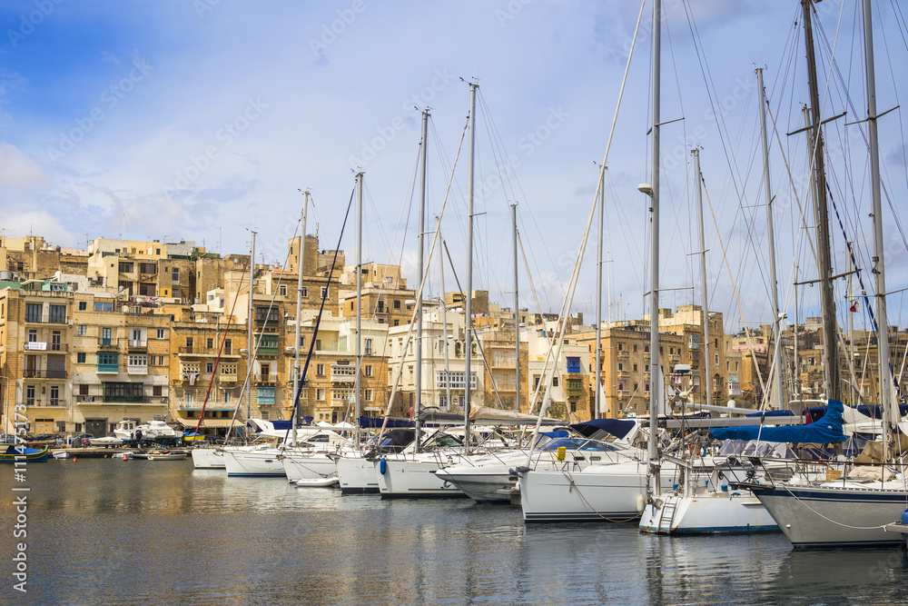 Malta - Yacht marina at Birgu with blue sky and clouds
