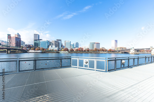 empty footpath on bridge with cityscape and skyline of portland