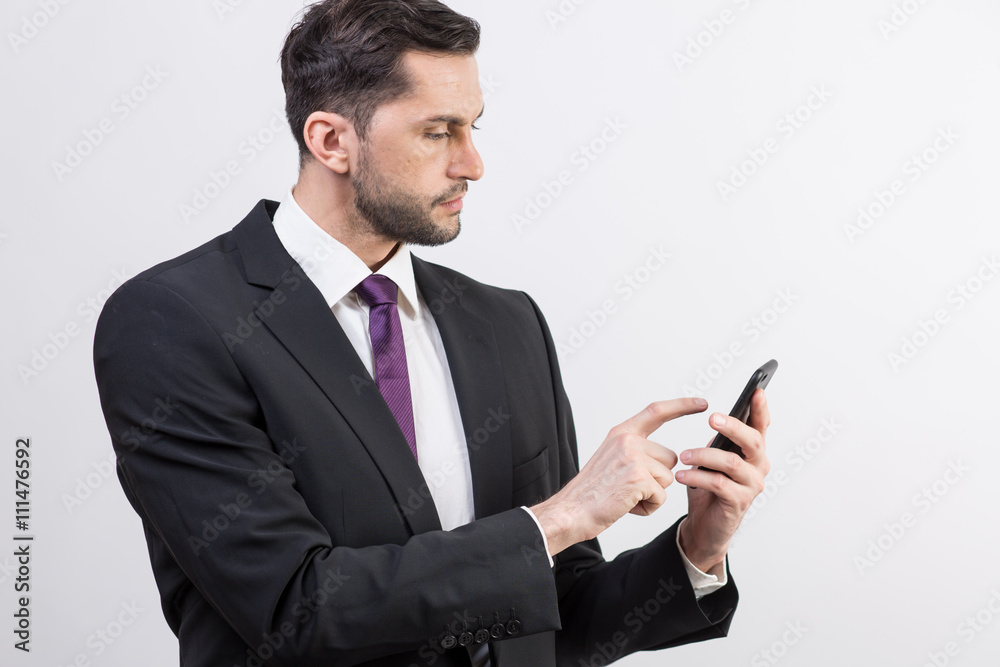 Young business man checks his phone Young business man checks his phone