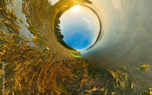 Foto kayak on river coast. Stereographic panorama, little planet