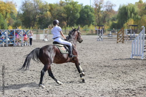 Competitor in show jump taking her course © skumer