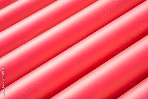 Stack of red pvc protective pipes