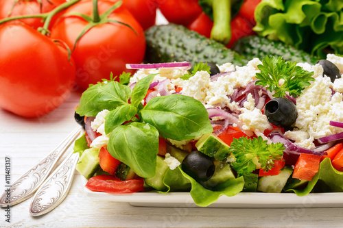 Vegetable salad with tomatoes, cucumbers, olives and feta cheese -bulgarian traditional summer salad.