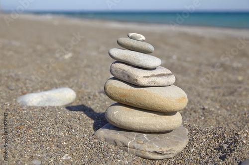 Stone pyramid on a pebble beach