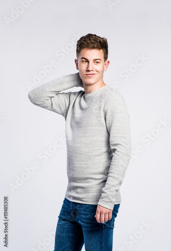 Boy in jeans and sweater, young man, studio shot © Halfpoint