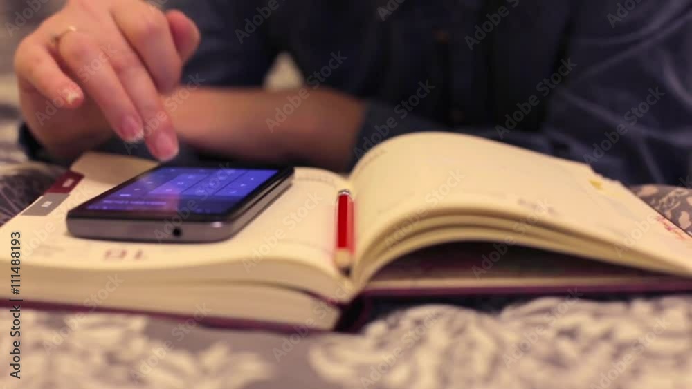 Woman doing calculations on your smartphone Woman doing calculations on your smartphone