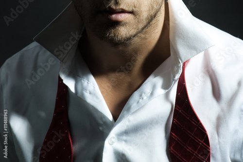 Macho man with untied red bow